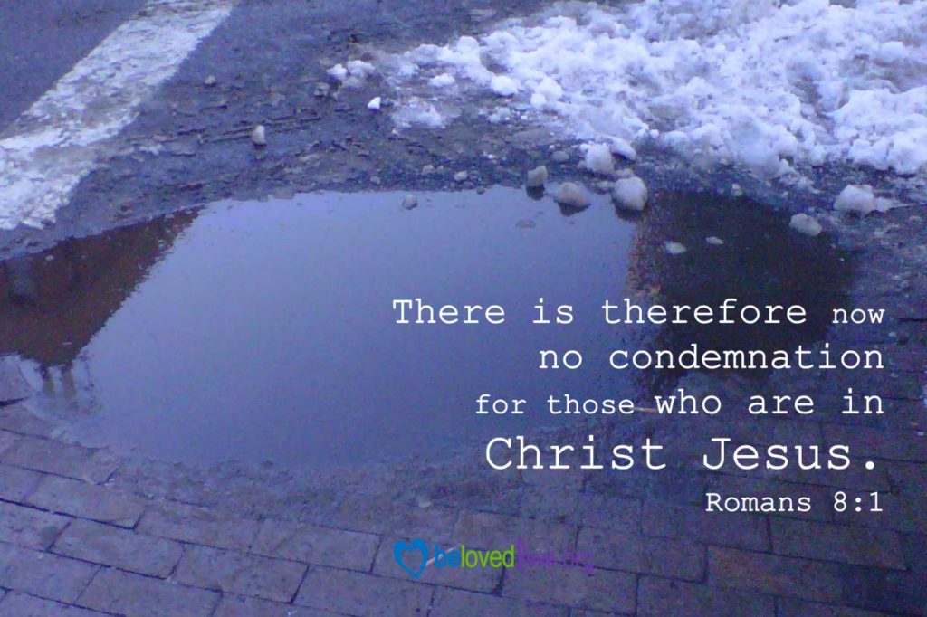 A small pool of dirty water in a parking lot, with melting snow adjacent.  Caption says, "There is therefore now no condemnation for those who are in Christ Jesus.  Romans 8:1