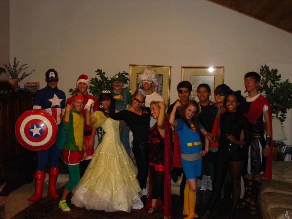 crowd of teenagers in superhero costumes