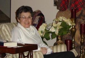 Older lady sitting by poinsettias